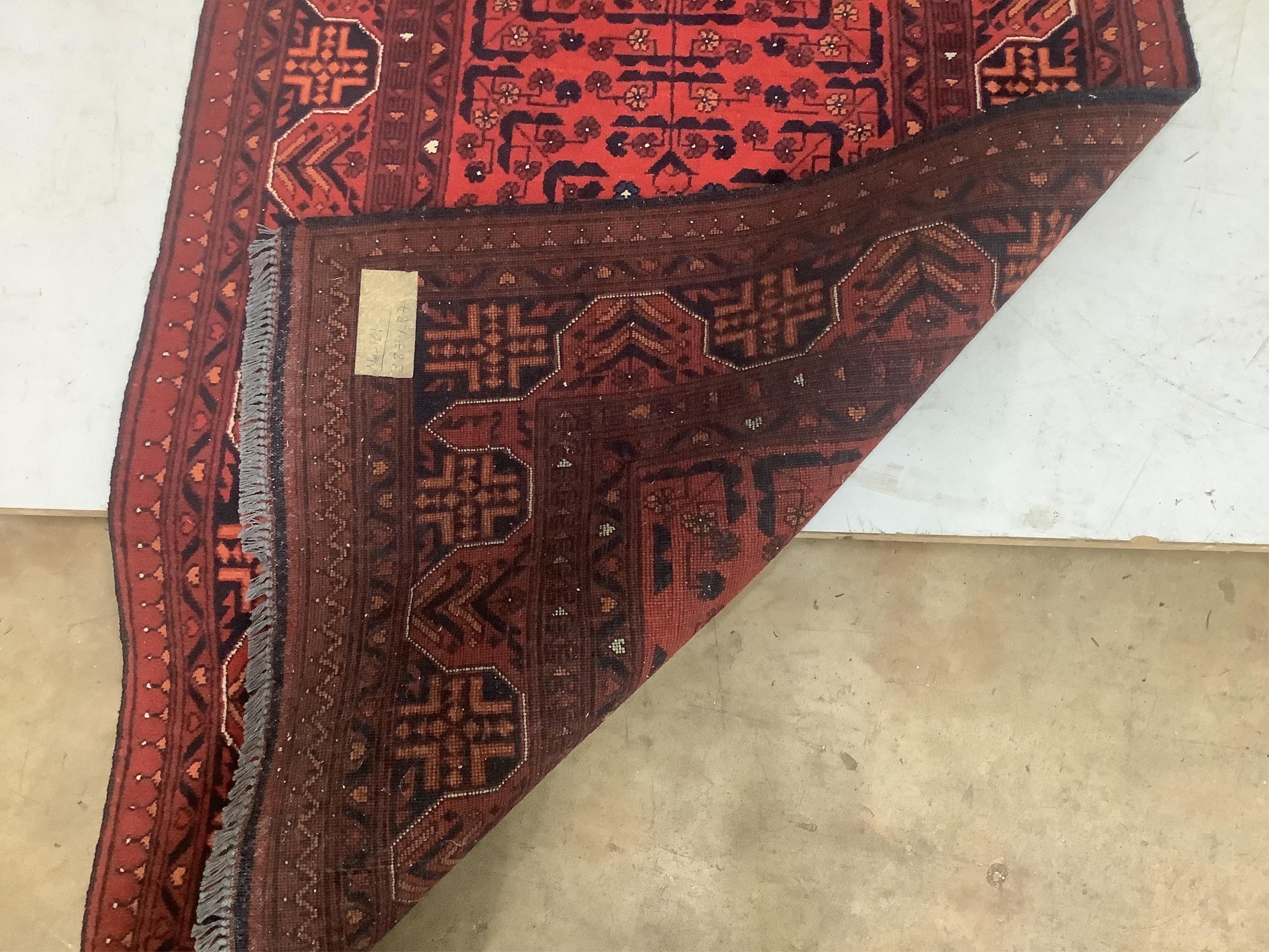 An Afghan red runner, 360 x 90cm. Condition - good